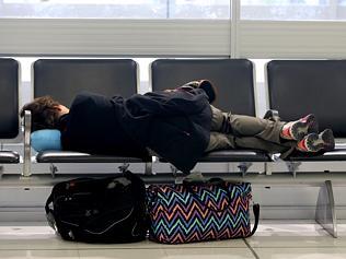 Jodie Green's four children aged 10, 9, 7 and 6, sleeping at Denpasar International Airport, waiting to get a flight home.