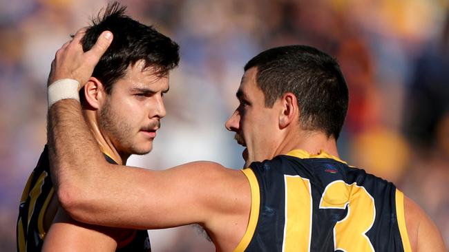 Darcy Fogarty of the Crows is congratulated by Taylor Walker after kicking a goal. Picture: AAP Image/Richard Wainwright.