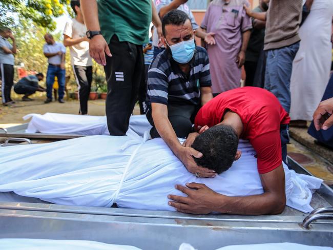 People mourn as they collect the bodies of Palestinians killed in Israeli air raids in Khan Yunis, Gaza. Picture: Getty Images