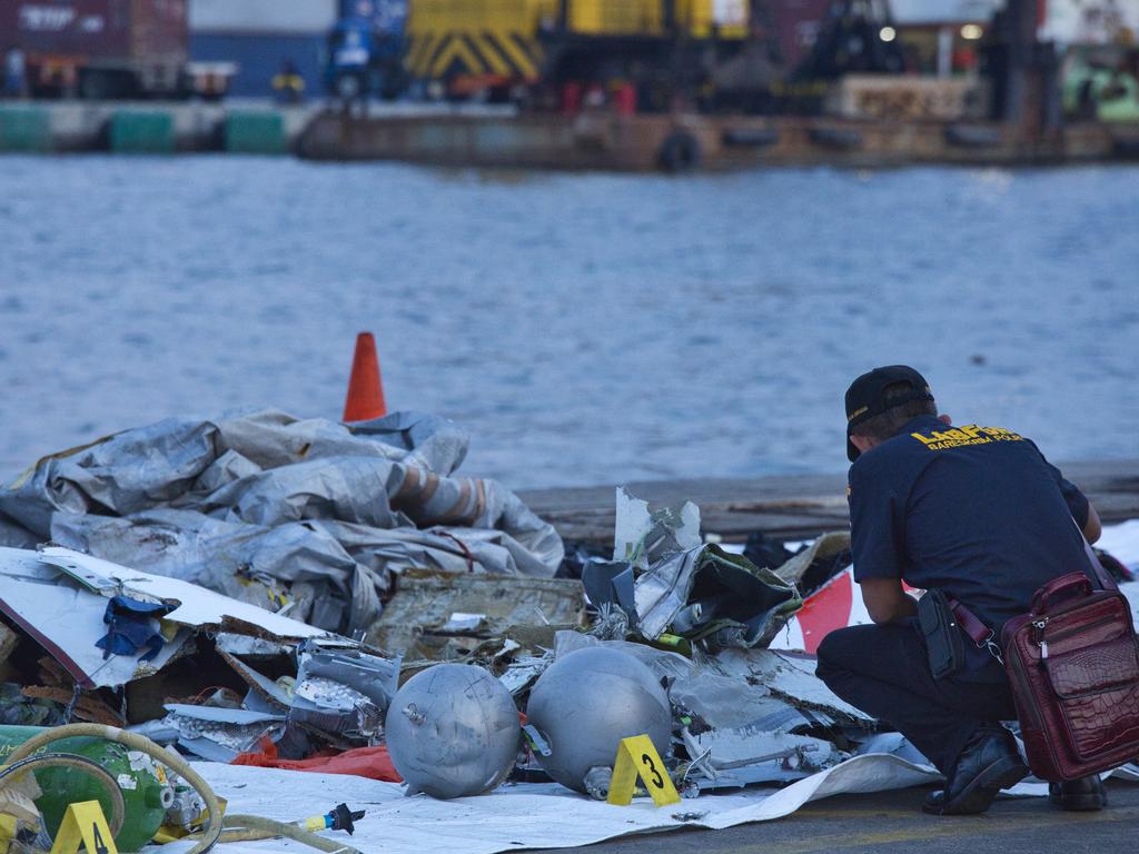 A forensic investigator looks through the remains of the Lion Air flight. Picture: Ed Wray/Getty