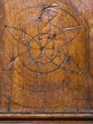 One of the daisy wheel-shaped symbols known as hexafoils, inscribed into the mantelpiece of the Richmond Courthouse in Tasmania.