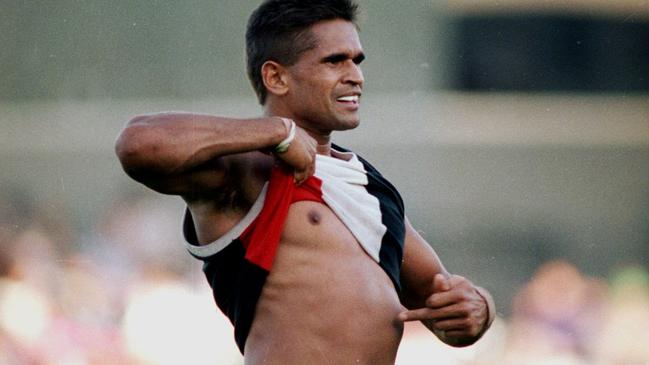 Nicky Winmar lifts his jumper and points to the colour of his skin in 1993. Pic John Feder