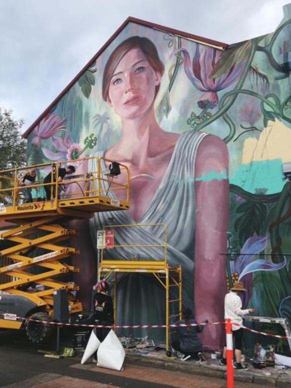 Ad agency Apparition Media working to paint over the Newtown street mural.