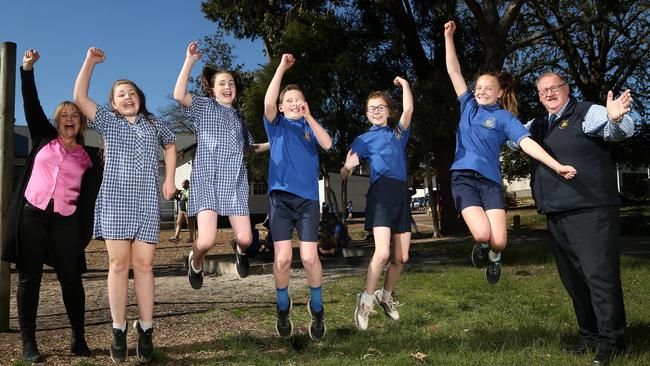 The Basin Primary School’s Donna Krenn with students Olivia, Scarlett, Riley, Teannah and Tahlia and principal Graeme Russell. Picture: Hamish Blair