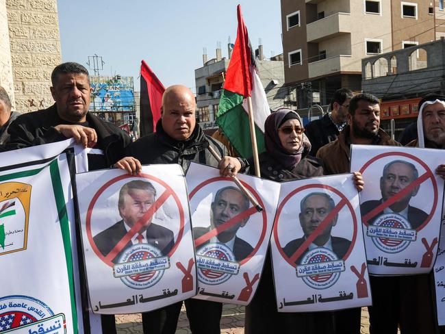 Palestinian demonstrators chant slogans while holding portraits of US President Donald Trump and Israeli Prime Minister Benjamin Netanyahu, during a protest against Trump's announcement of a peace plan, in Rafah in the southern Gaza strip. Picture: AFP