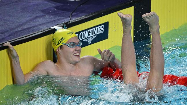 Silver medallist Australia's Timothy Hodge (L) reacts as New Zealand's Joshua Willmer sinks in to the water as he celebrates winning and taking the gold medal in the men’s 100m backstroke S8 swimming final on day three of the Commonwealth Games in Birmingham in 2022. (Photo by Oli SCARFF / AFP)