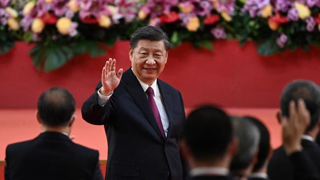 China's President Xi Jinping waves following his speech after a ceremony to inaugurate the city's new leader and government in Hong Kong on July 1.