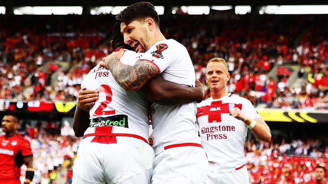 Jermaine McGillvary of England celebrates after scoring a try with Gareth Widdop during the 2017 Rugby League World Cup semi final match against Tonga.