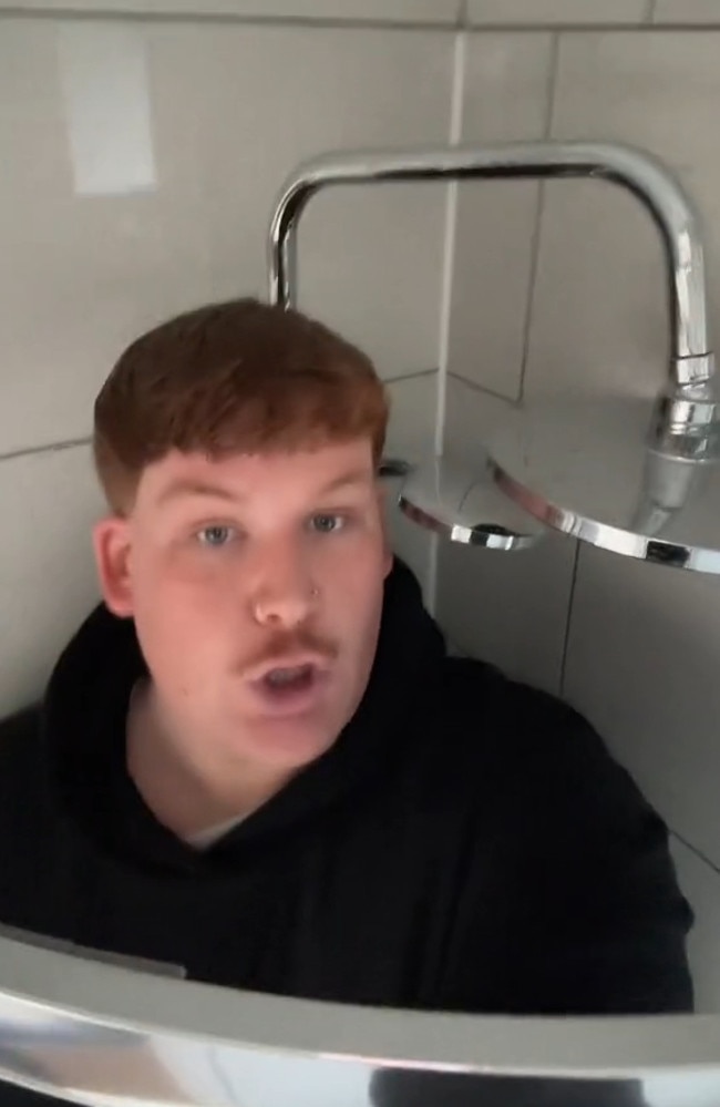 Kane Hinge, who describes himself as “the big friendly ginger”, was also taller than the shower head. Pictures: TikTok / @kanehinge