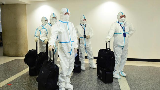 The flight crew from Air China arrive in hazmat suits in the international terminal at Los Angeles International Airport. Picture: AFP.