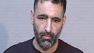 Michael Sahartor was arrested at Canberra Airport and charged with 43 counts of damage and destroy property. Picture: NSW Police