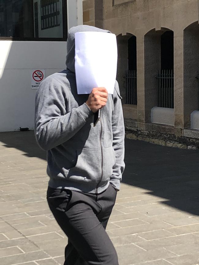 Matthew Hiesgen tried to hide his face as he left court on Tuesday. Picture: Madeline Crittenden.