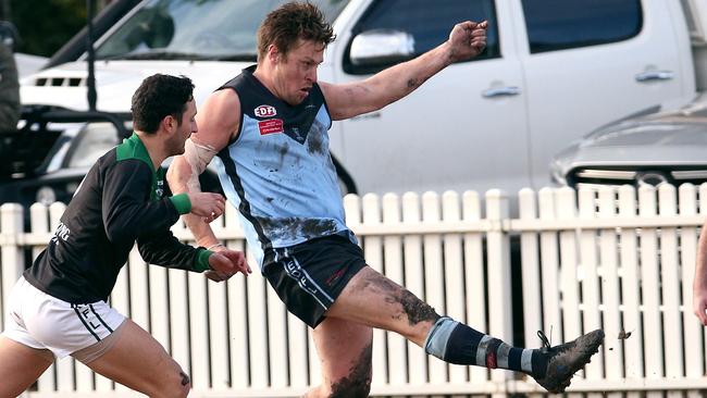 EDFL footy: Aberfeldie v Greenvale: Nicholas Meese of Aberfeldie kicks under pressure from Daniel Micevski of Greenvale Saturday, July 3, 2021, in Aberfeldie, Victoria, Australia. Picture: Hamish Blair