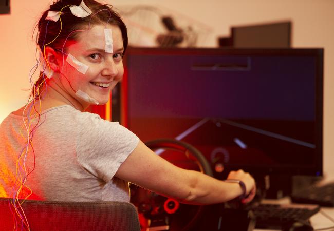 Dr Steph Chappel, researcher at the Appleton Institute in Adelaide, drives a car simulator with electrodes attached to her head to examine the effects of fatigue. Picture: Emma Brasier