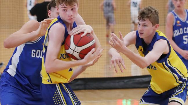 Basketball Queensland Under-16 Boys State Championships at the Coomera Indoor Sports Centre. Gold Coast Rollers v Townsville Heat Division 1 game . Rollers Sam Scott and Heats Oliver Timms (with ball) and Jack Abbott. Picture Glenn Hampson