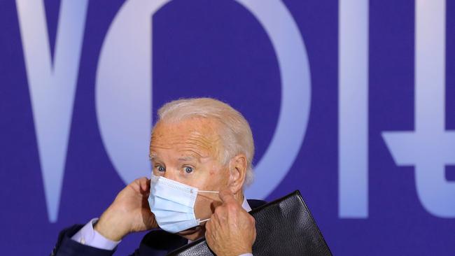 Joe Biden replaces his face mask after speaking in the Cincinnati Museum Centre in Cincinnati, Ohio. Picture: AFP