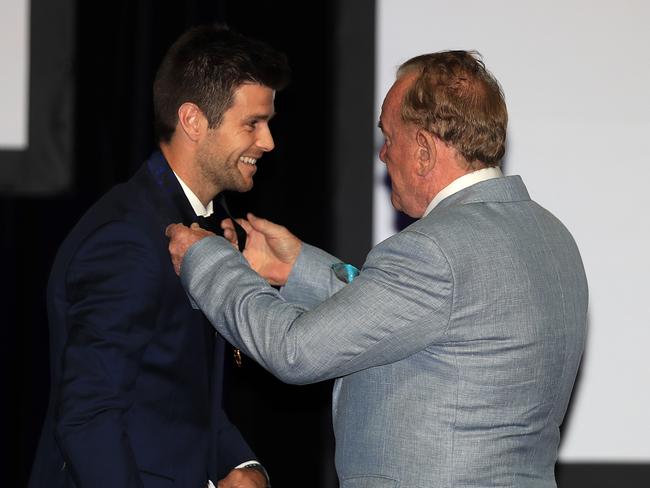 Cotchin is awarded his medal by triple Brownlow winner Ian Stewart. Picture: Alex Coppel