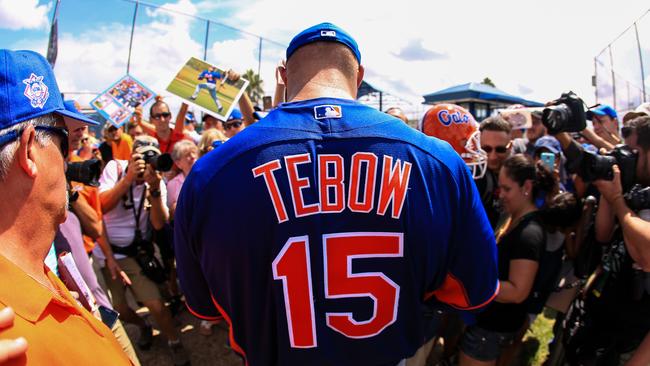 Tim Tebow #15 of the New York Mets signs autographs.