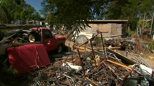 Piles of rubbish stacked up in the yard.