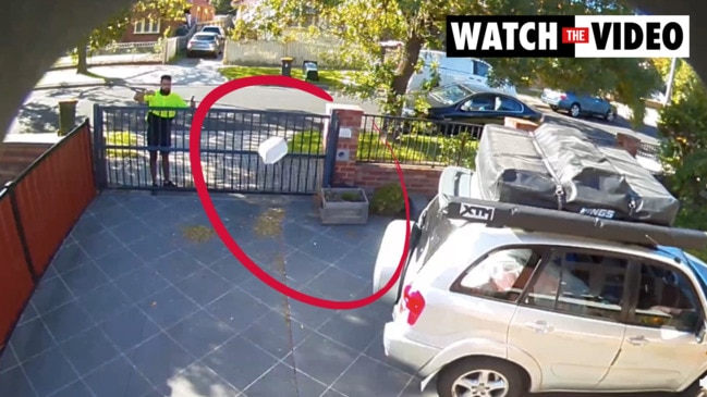 Delivery driver throws parcel over gate