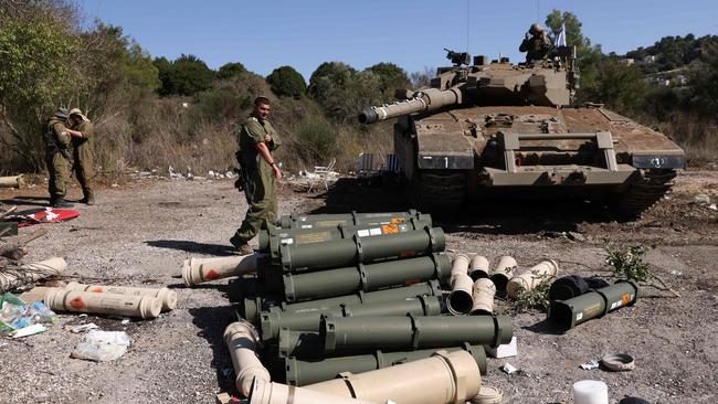 Israeli soldiers stand near a Merkava tank as they man a position at an undisclosed location on the border with Lebanon. Picture: AFP