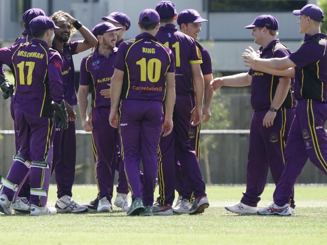 McKinnon players celebrate a wicket on Saturday. Picture: Valeriu Campan