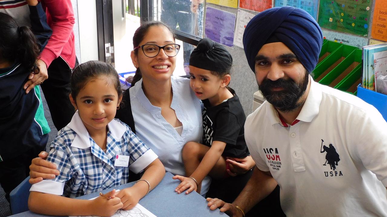 One student with her parents and younger brother.