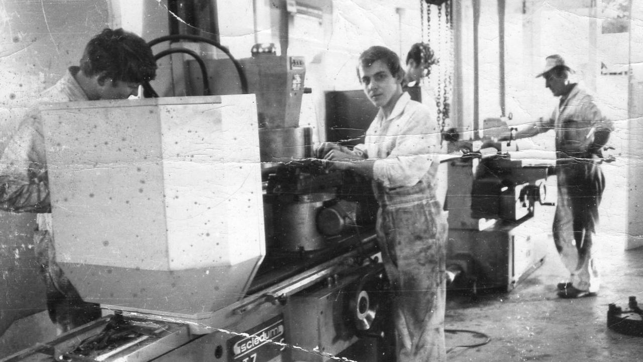 Gerald Cullen (front right) and his father Alwyn (right back) working together in their shop in Nambour.