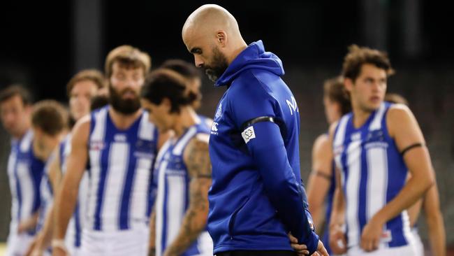 North Melbourne coach Rhyce Shaw pause for a minutes silence in memory of John Kennedy Senior before the Round 4 match this season. Picture: Michael Willson/Getty