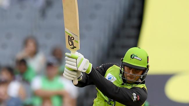 Usman Khawaja of the Thunder plays a shot during the Big Bash League (BBL) match between the Melbourne Stars and the Sydney Thunder at the MCG in Melbourne, Saturday, January 20, 2018. (AAP Image/Mal Fairclough) NO ARCHIVING, EDITORIAL USE ONLY