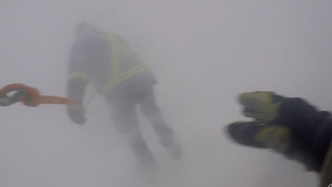 Visibility was at zero for days on end after an incredible blizzard kept Antarctic expeditioners at the Mawson base locked down for a week. Pictured are two expeditioners on a “blizz line” (blizzard line) outside after the storm to check for damage.