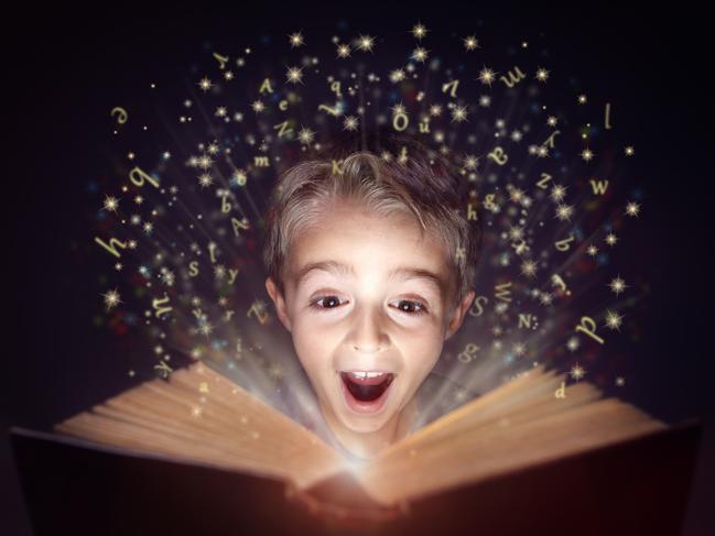 Child reading a magicical story book with letters leaping off the page