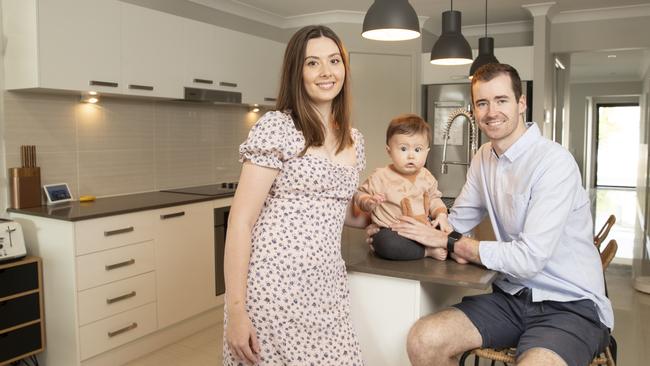 Jessica McDonald and Harry Cann with their 8 month old son, Theo, at their home in North Lakes, which they have listed for sale. Picture: Lachie Millard.