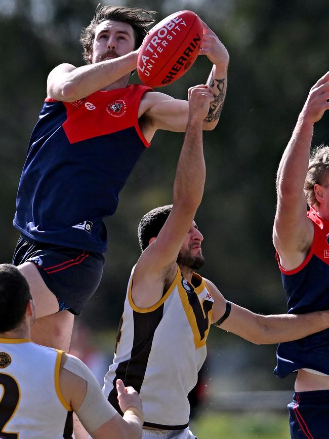 Diamond Creek’s Robby Noble flies over Thomastown’s Daniel Caruso. Picture: Andy Brownbill