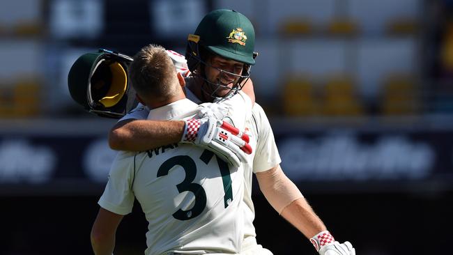 Australia's batsman Joe Burns (R) greets teammate David Warner (L) for his century. Picture: AFP