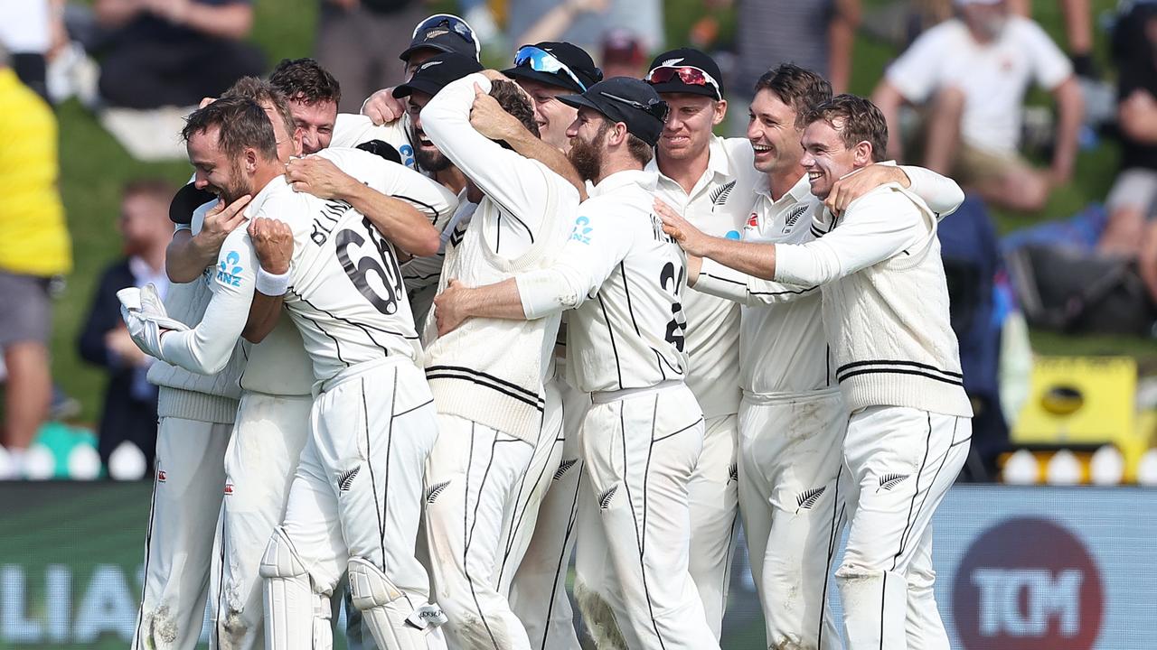 New Zealand players celebrate their one-run victory.