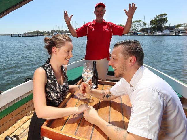 HOLD FOR HERALD SUN PIC DESK----East Gippsland tourism in fire affected areas, in attempts to draw the crowds back to seaside locations and small country towns. Paynesville. Peter Medling [President of Paynesville Classic Boat Rally, on his 1936 Gippsland Lakes Fishing Boat ] with Mark and Victoria  Briggs [owners and chef of Sardine Paynesville Eatery Bar].   Picture: Alex Coppel.