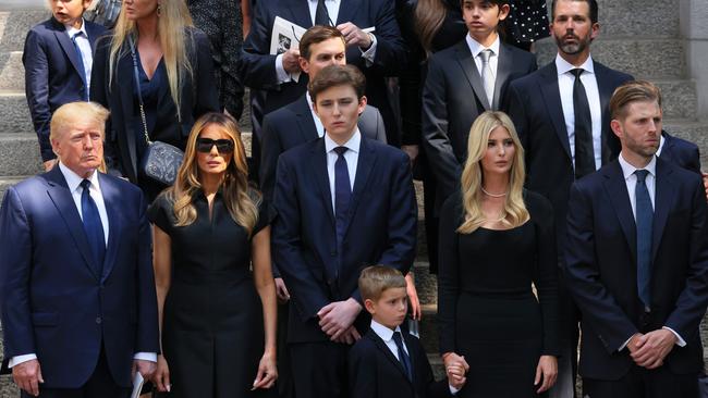 NEW YORK, NEW YORK - JULY 20: former U.S. President Donald Trump and his wife Melania Trump along with their son Barron Trump and Ivanka Trump, Eric Trump and Donald Trump Jr. and their children watch as the casket of Ivana Trump is put in a hearse outside of St. Vincent Ferrer Roman Catholic Church during her funeral on July 20, 2022 in New York City. Trump, the first wife of former U.S. President Donald Trump,  died at the age of 73 after a fall down the stairs of her Manhattan home. (Photo by Michael M. Santiago/Getty Images)