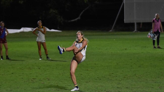 Bond forward Taylor Smith kicks one of her two goals against University of Queensland. Pic: Claudia Moodoonuthi Jones