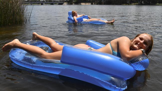 Mia Allanson, front, and her bestie Lily Boyle relax on the lagoon near Narrabeen Bridge on Sydney’s northern beaches. Picture: Sam Mooy