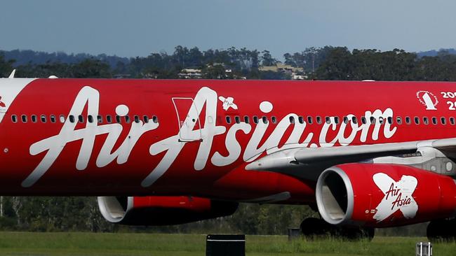 AirAsia passengers playing from Kuala Lumpur disembarking at the Gold Coast Airport at Coolangatta. For story on travellers regarding the AirAsia plane loss. Picture: JERAD WILLIAMS