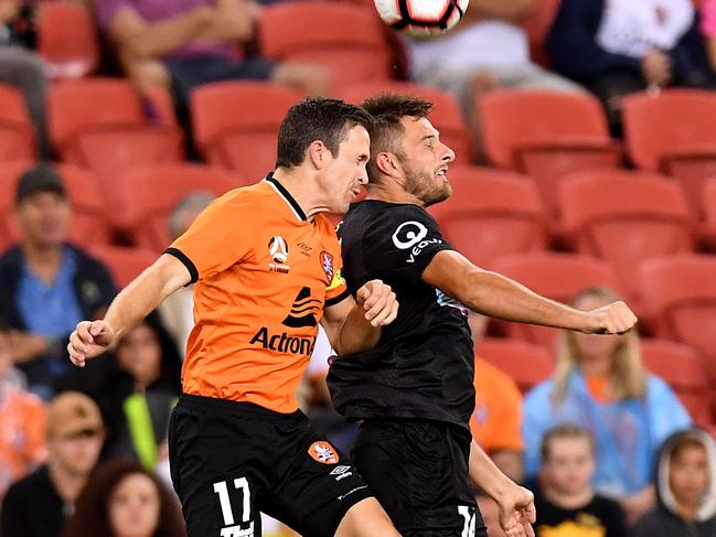 Brisbane Roar captain Matt McKay (left) and Newcastle’s Kaine Sheppard compete for the ball on Saturday night. Picture: Getty Images 