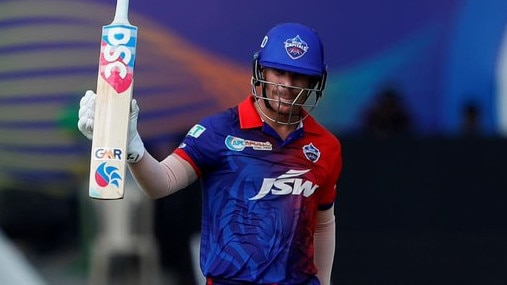 David Warner raises his bat during the IPL after hitting 50 for the Delhi Capitals. Photo: Twitter