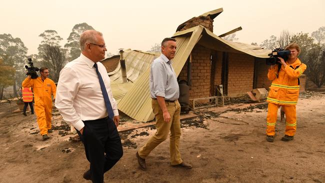 Prime Minister Scott Morrison and MP Darren Chester at a fire-ravaged farm in Sarsfield last year. Picture: AAP Image/James Ross