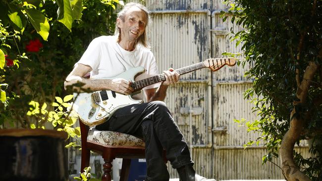 Reg Mombassa playing his 1969 Fender Stratocaster Blue L series guitar in his backyard. Pictures: John Appleyard