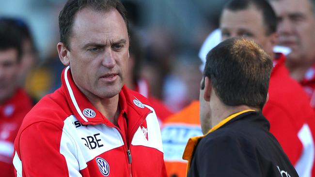 Alastair Clarkson and John Longmire shake hands.