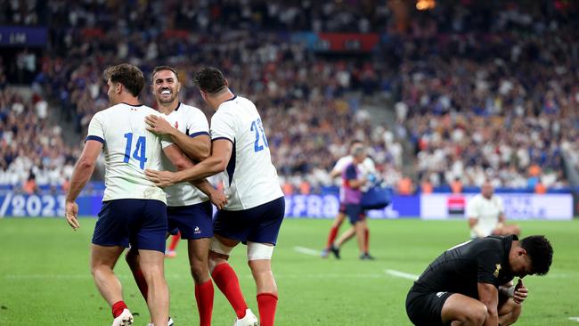 PARIS, FRANCE - SEPTEMBER 08: Melvyn Jaminet, Damian Penaud and Paul Boudehent of France celebrate their side's second try as Richie Mo'unga of New Zealand looks dejected during the Rugby World Cup France 2023 Pool A match between France and New Zealand at Stade de France on September 08, 2023 in Paris, France. (Photo by Warren Little/Getty Images)