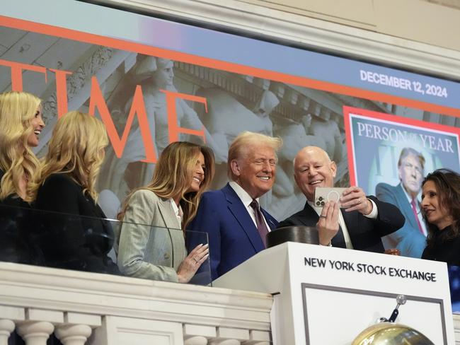 President-elect Donald Trump stands for a selfie after ringing the opening bell at the New York Stock Exchange. Picture: AP