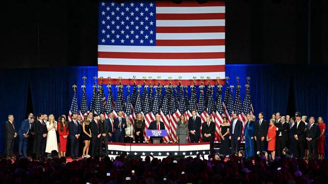 The Trump clan and their inner circle gather on the stage at the West Palm Beach Convention Center in West Palm Beach, Florida. Picture: AFP.