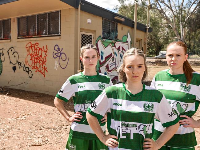 MARCH 16, 2024: Mercedes Old Collegiate Soccer Club women's captain Madeleine Price, centre, with team mates Hannah George and Ellie Teitzel at their derelict clubrooms in Park 21. Picture: Brenton Edwards